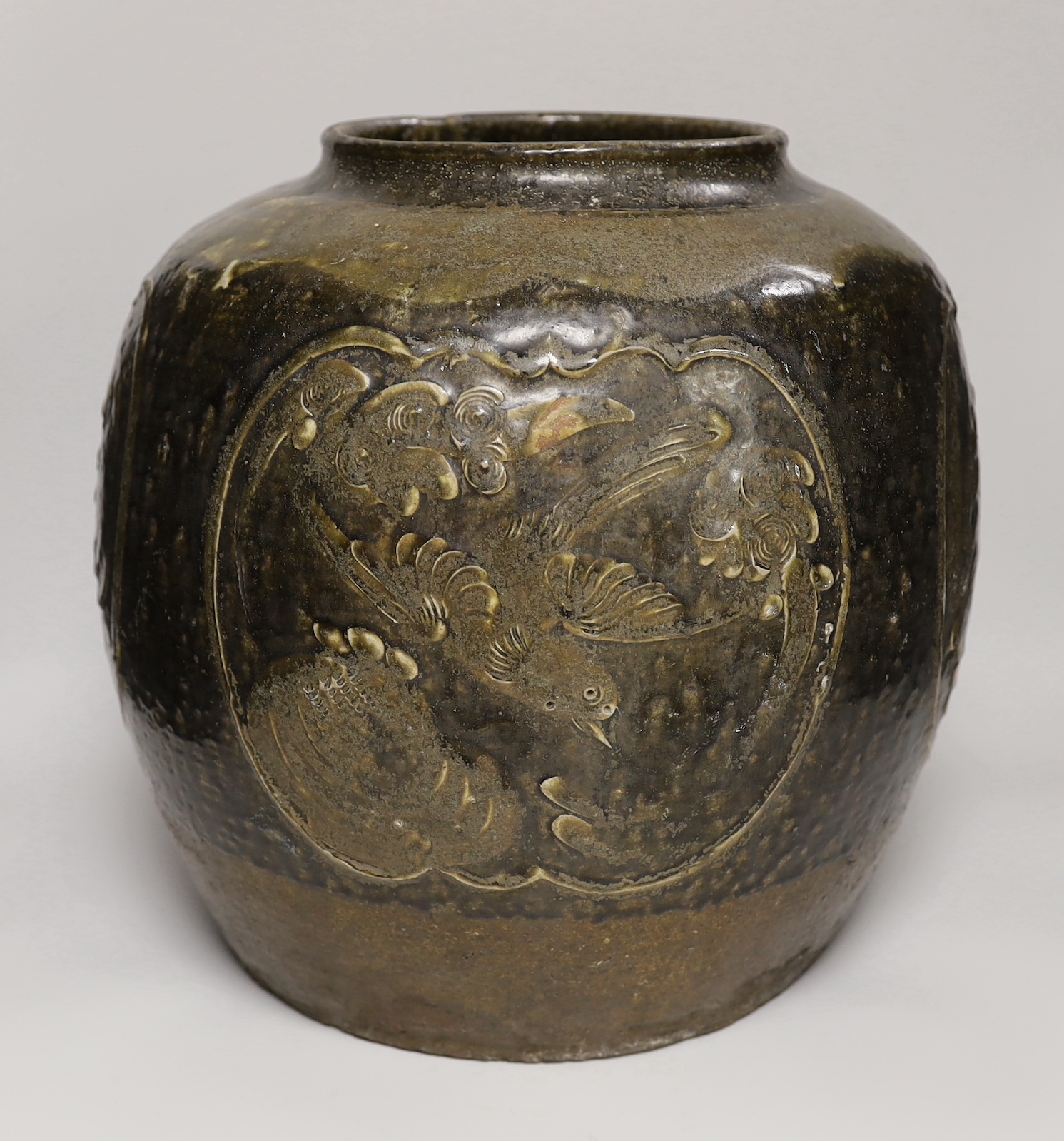 A large Chinese stoneware ovoid jar, decorated in relief with birds and flowers, possibly 19th century, 36cm high